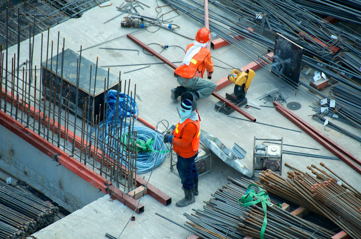 Construction site with builders at work